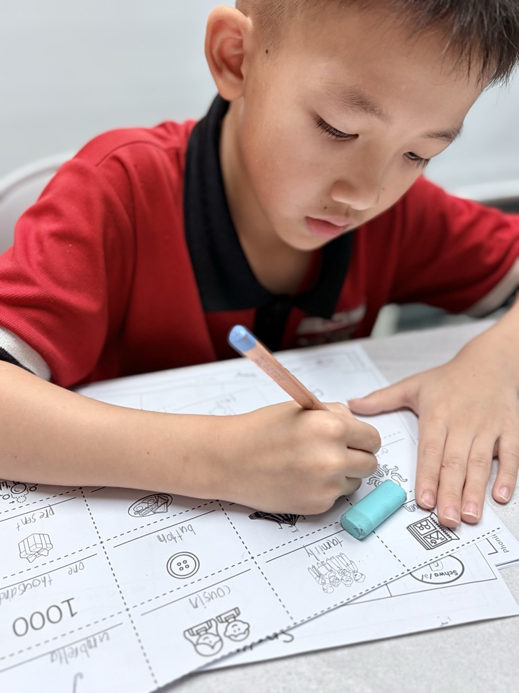 A child writing words during a schwa spelling-pattern activity